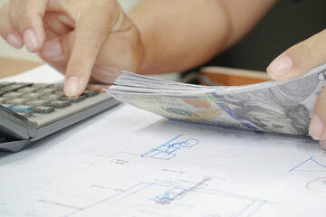 Women counting dollar bills, finances and accounts.