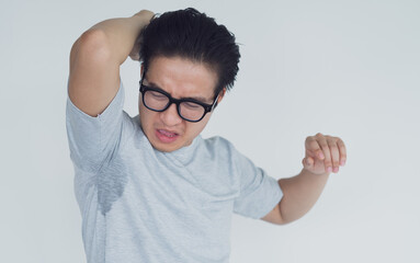 photo of Asian man with underarm odor
 - obrazy, fototapety, plakaty
