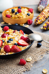 cornflakes with strawberries, blueberries and raspberries