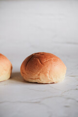 Freshly baked bread. Organic whole-wheat loaves on white background. Mini bread pile. Bakery bread buns merchandise.