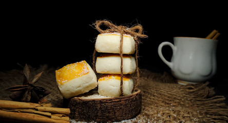 Closeup composition of Tea setup with baked biscuits or cookies and tea cup decorated with Cinnamon roll and star anise in a isolated rustic background. Butter biscuits.Pastry. Dark food photography.