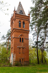 Fototapeta na wymiar Old brick water tower in Natalyevka park in Kharkiv region, Ukraine