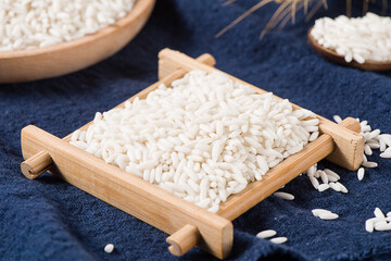 Raw organic white rice on wooden background, glutinous rice or sticky rice close up