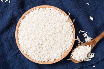 Raw organic white rice on wooden background, glutinous rice or sticky rice close up