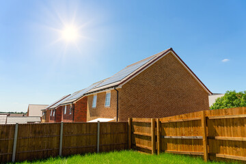 Houses with solar panels capture sun light. English architecture