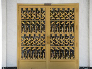 A set of brass pattern doors to a catholic church. 