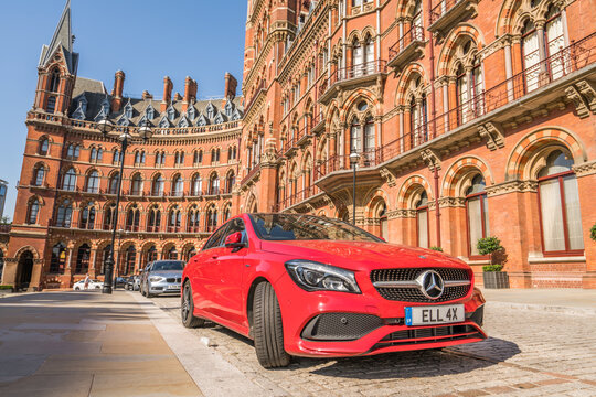 LONDON,ENGLAND-SEPT 12,2018:Red Mercedes-Benz CLA parked in front of St. Pancras Station.It is a series of subcompact executive cars manufactured by Mercedes-Benz since 2013