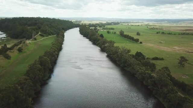 Aerial footage getting lower over the Snowy River between Marlo and Orbost, in Gippsland, Victoria, Australia, December 2020