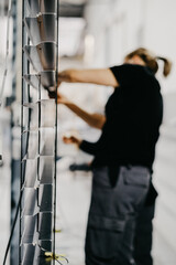 Worker assembling Venetian blinds in a factory
