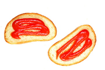 Pair of slice white bread with tomato sauce smeared with red hot ketchup isolated on white background