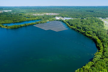 Aerial view of solar power station float on water pond, in the electric renewable ecological energy
