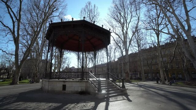 People around pavillion in Zrinjevac park Zagreb. People relaxing on a bench near Academy of Science and Arts in Zagreb