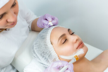 Facial skin care and protection. A young woman at a beauticians appointment. The procedure for applying a mask on the face