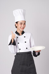 Beautiful young asian woman chef holding empty white plate on white background.