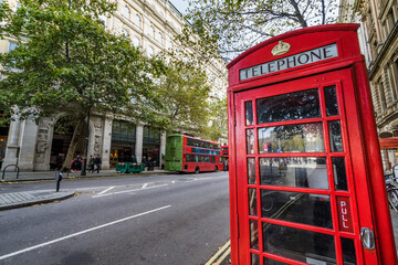 London, the UK. Red phone booth and red bus in background. English icons