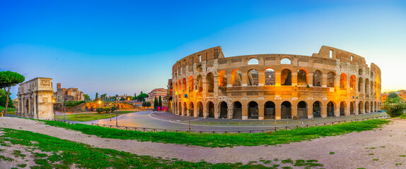 Colosseum and Constantine arch at dawn in Rome, Italy 