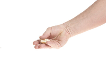 Hand holds a plastic dowel for screws on a white background
