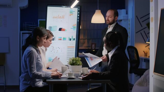 Furious nervously businessman screaming while working in office meeting room late at night. Exhausted disappointed entrepreneur man throwing company statistics paperwork leaving business office