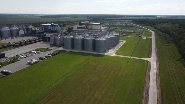 long rows of huge white gas tanks connected with pipeline system at refinery plant on sunny day aerial view