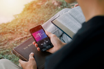 Two adults worship with smartphone at home. Progress Bar Loading with the text: Jesus on smartphone screen. Church online concept.
