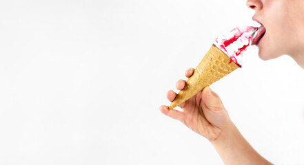 Multicolored ice cream cone in hand. The girl is eating ice cream. On white background.