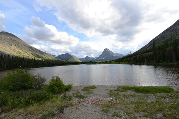 Scenic view of mountains, trees and a lake at Glacier National Park in Montana