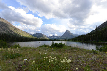 Fototapeta na wymiar Scenic view of mountains, trees and a lake at Glacier National Park in Montana