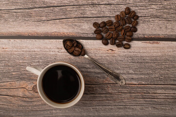 dark coffee and grains on wooden background