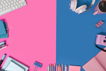 Office supplies on two tone blue and pink background.