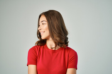 Obraz premium pretty brunette in red t-shirt posing fashion studio