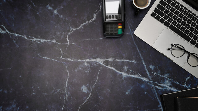 Mock up laptop computer, coffee cup and payment terminal on marble background. - Powered by Adobe