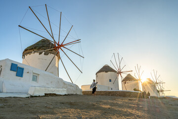 Famous windmills of Mykonos island with sunset flare 