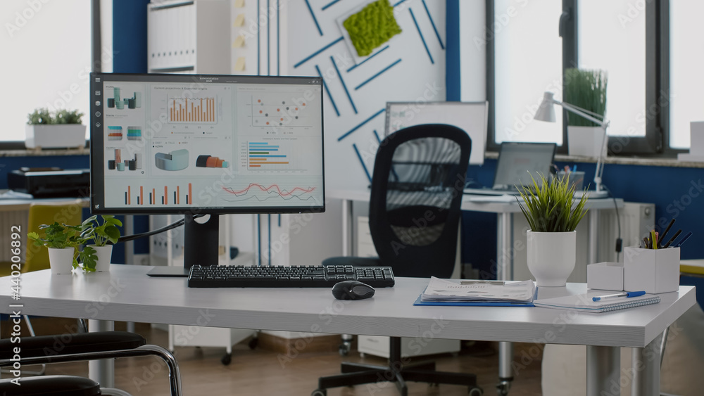 Poster computer display with data, prosessing financial information and graphs monitoring economy in empty 