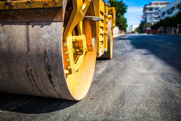 Close up on the road roller working on the new road construction site.