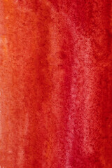 Red smudges of paint on watercolor paper