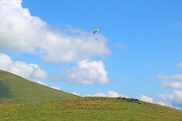 People Enjoy Paragliding over the Lush Peak of Caucasus Mountains, Georgia