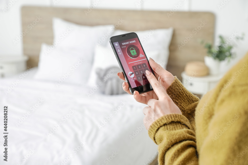 Poster woman with mobile phone using smart home security system application