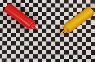Ketchup and Mustard Bottles on Black and White Checkered Table