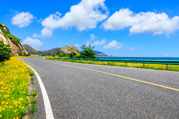 Asphalt highway and mountain with blue sea natural landscape.