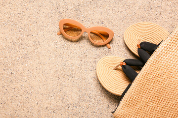 Stylish beach accessories on sand