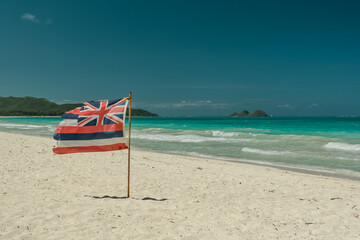 Hawaii state flag on the beach. Waimanalo Bay State Recreation Park, Oahu, Hawaii. The longest...
