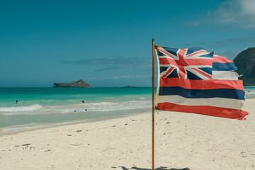 Hawaii state flag on the beach. Waimanalo Bay State Recreation Park, Oahu, Hawaii. The longest...