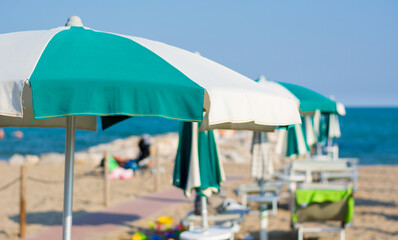 beach umbrellas open on the beach in front of the sea