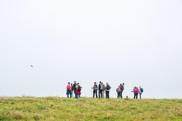 Obraz na płótnie Canvas Group with bird watchers on a meadow