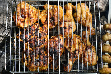 Delicious chicken meat barbecue with golden crust and grilled mushroms.