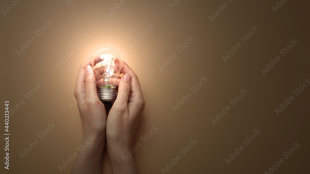 Poster a burning lamp in the hands of a man. the emergence of a creative idea for solving a complex problem