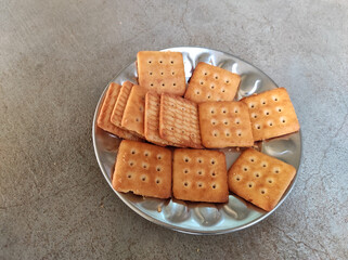 High-angle shot of a plate with crackers on the table