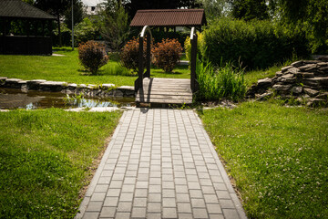 Footpath with grass texture background, paved path pattern