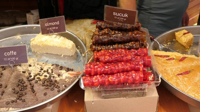 Layout showcase of goodies at the fair - variety of Turkish sweets: halva, marshmallow, Turkish delight, churchkhela