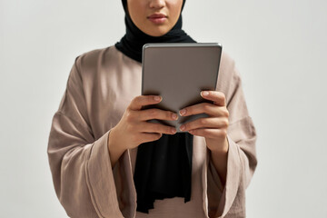 Digital tablet in young arabic woman hands